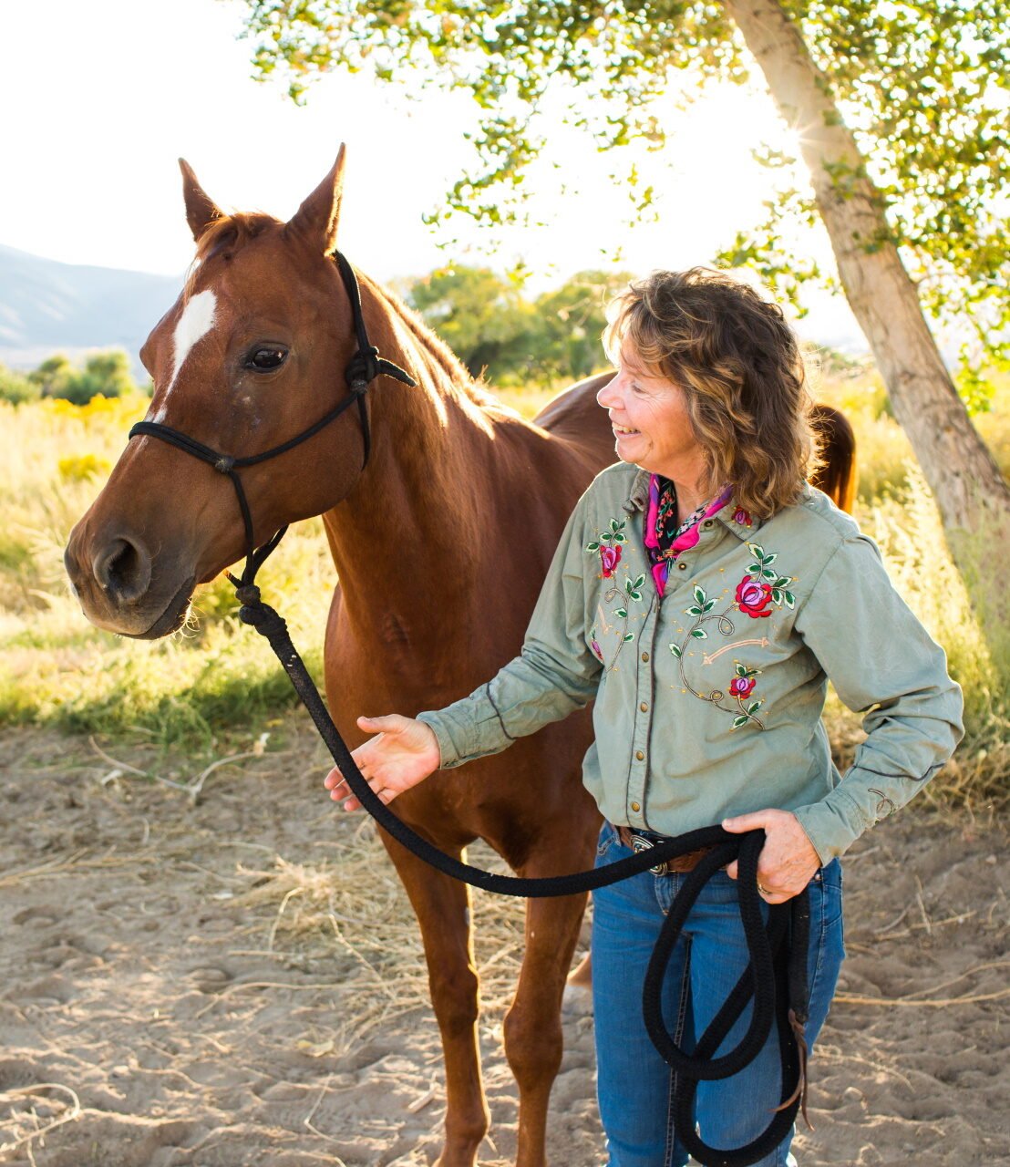 HEAL Director Leigh Shambo along side a horse for Human Equine Alliance